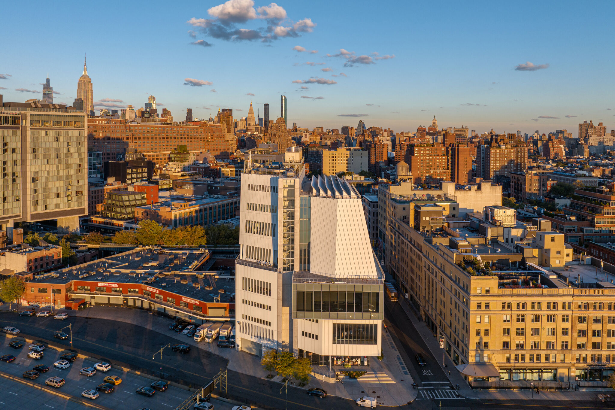 Aerial view of the Whitney Museum of American Art, a modern building with unique architecture, against a cityscape.