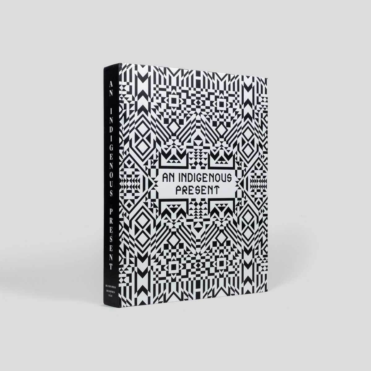 A book with a black and white geometric patterned cover titled "An Indigenous Present" on a white background.