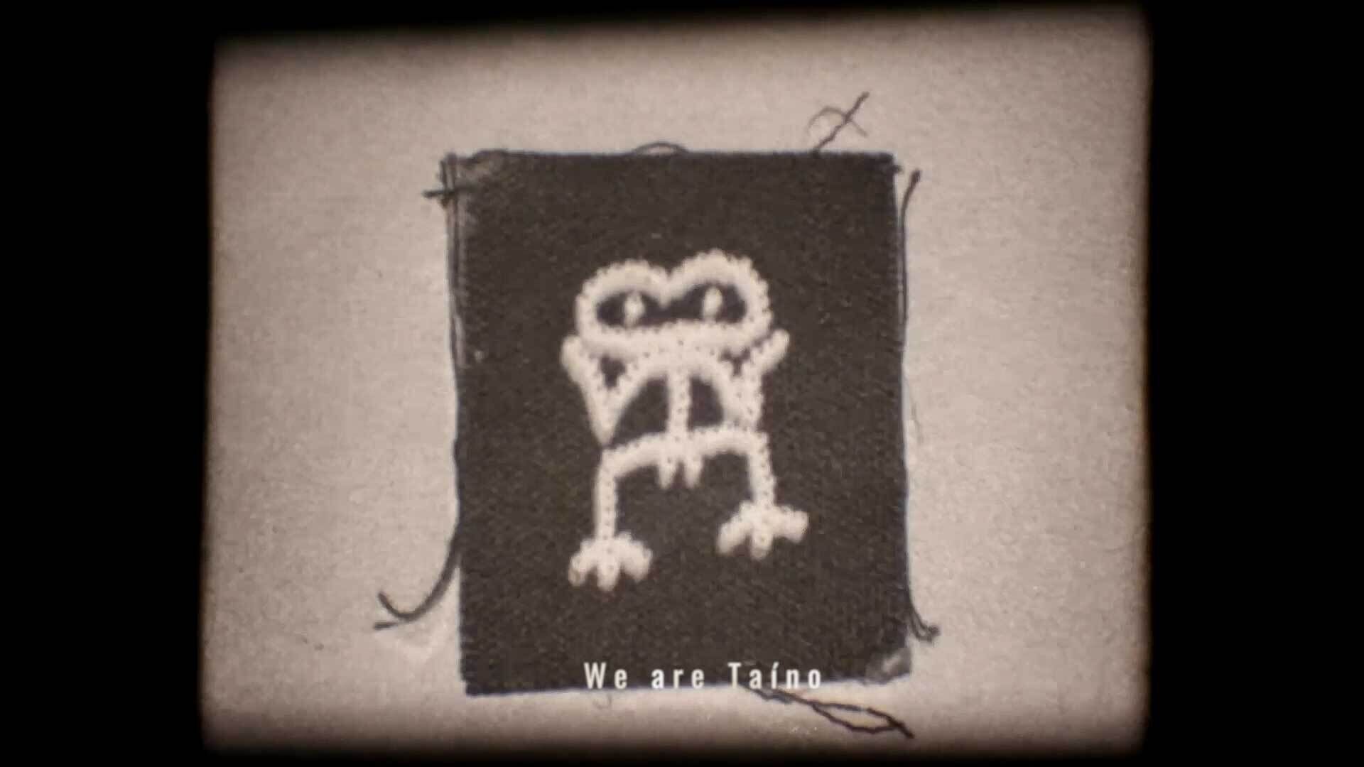 A stitched figure on fabric with the caption "We are Taíno" displayed on a grainy background.