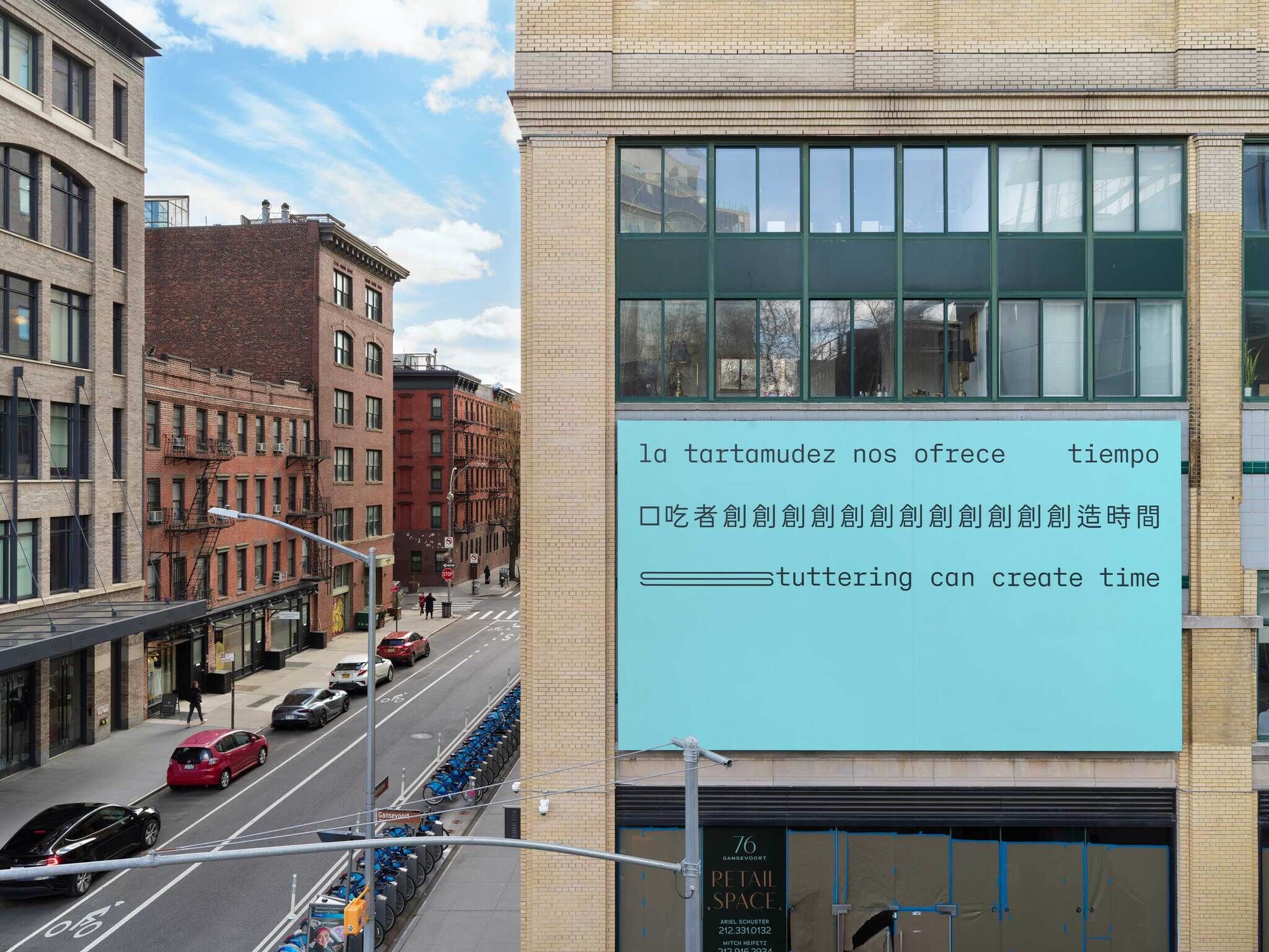 Urban street view with a building displaying a multilingual message about stuttering creating time.