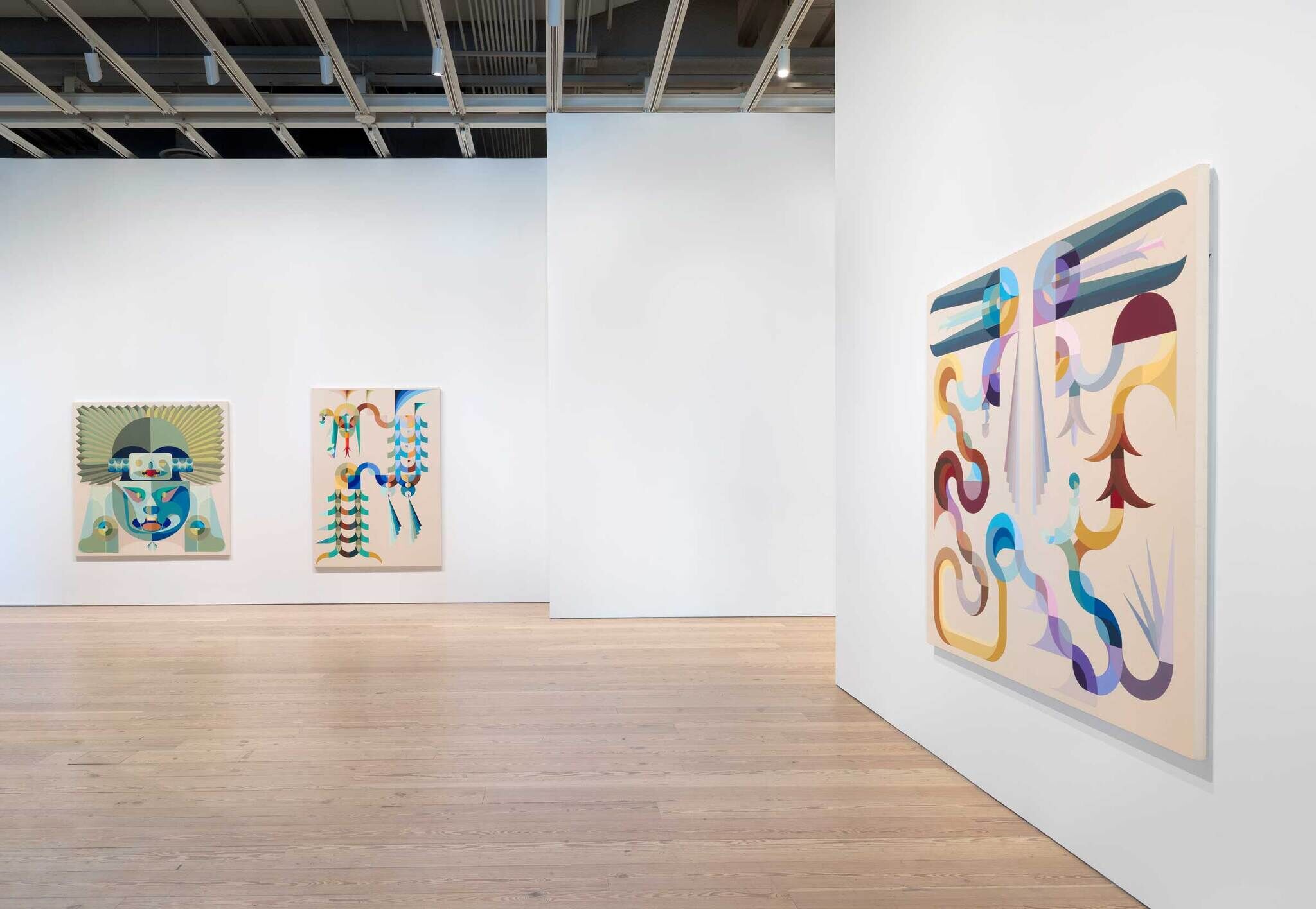 Modern art gallery interior with two colorful abstract paintings on white walls, wooden floor, and industrial ceiling.