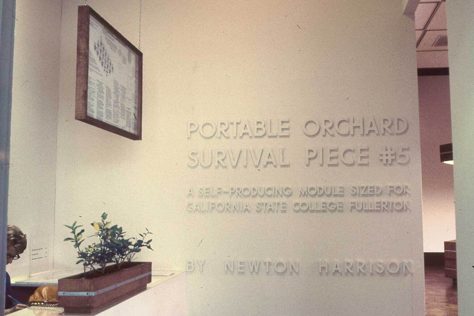 "Portable Orchard Survival Piece #5" by Newton Harrison, at for California State College Fullerton, displayed on a wall.