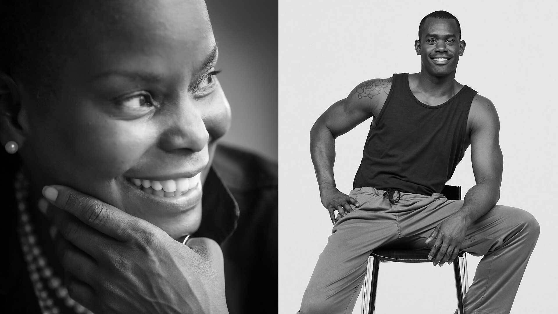 Black and white photo of a smiling woman resting her chin on her hand, next to a man sitting on a stool, wearing a tank top and pants.