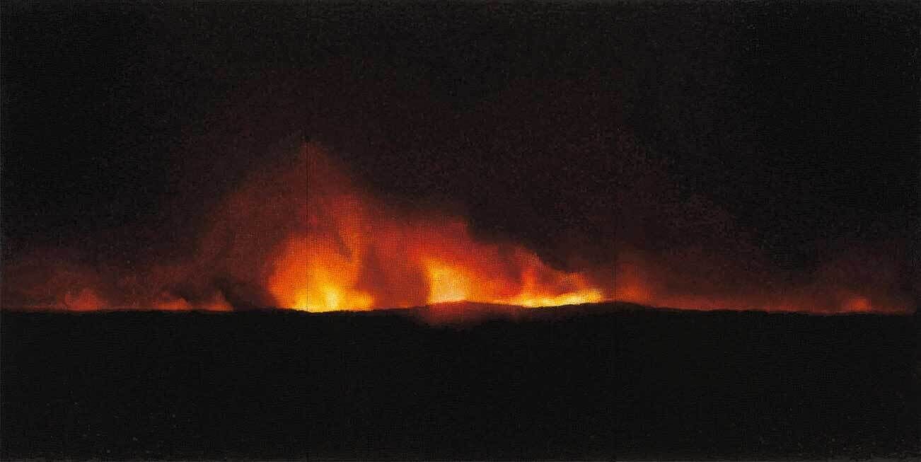 Backlit landscape of black hills surrounded by a fiery volcanic eruption.