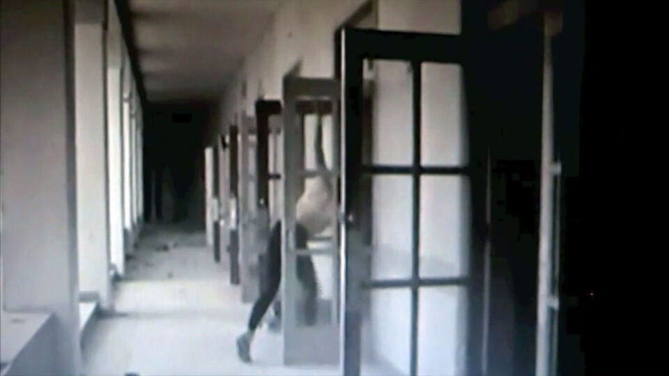 A person runs down a hallway, jumping through a series of open door frames.