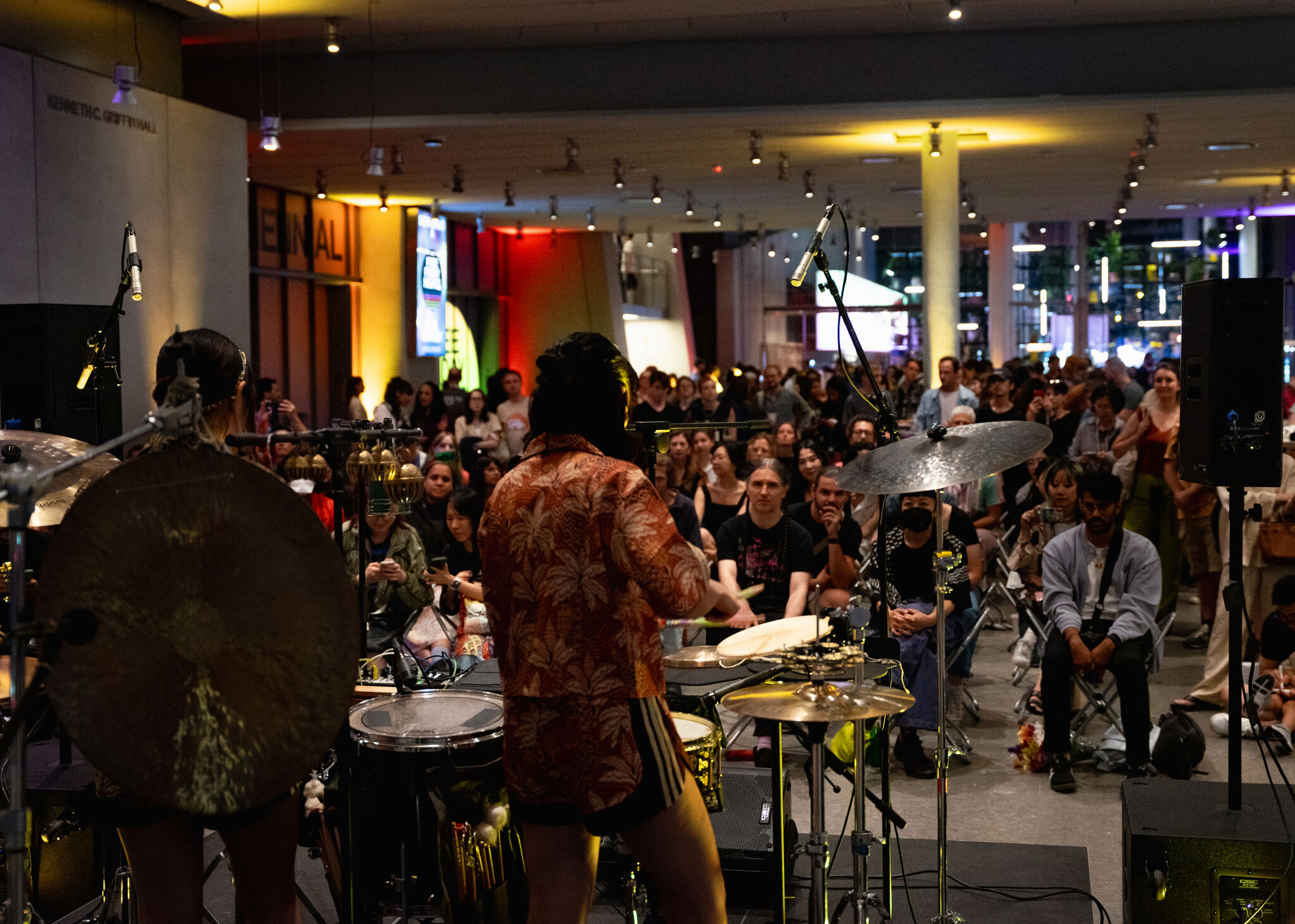 Percussion duo NOMON perform in front of a packed crowd at the Whitney Museum of American Art.