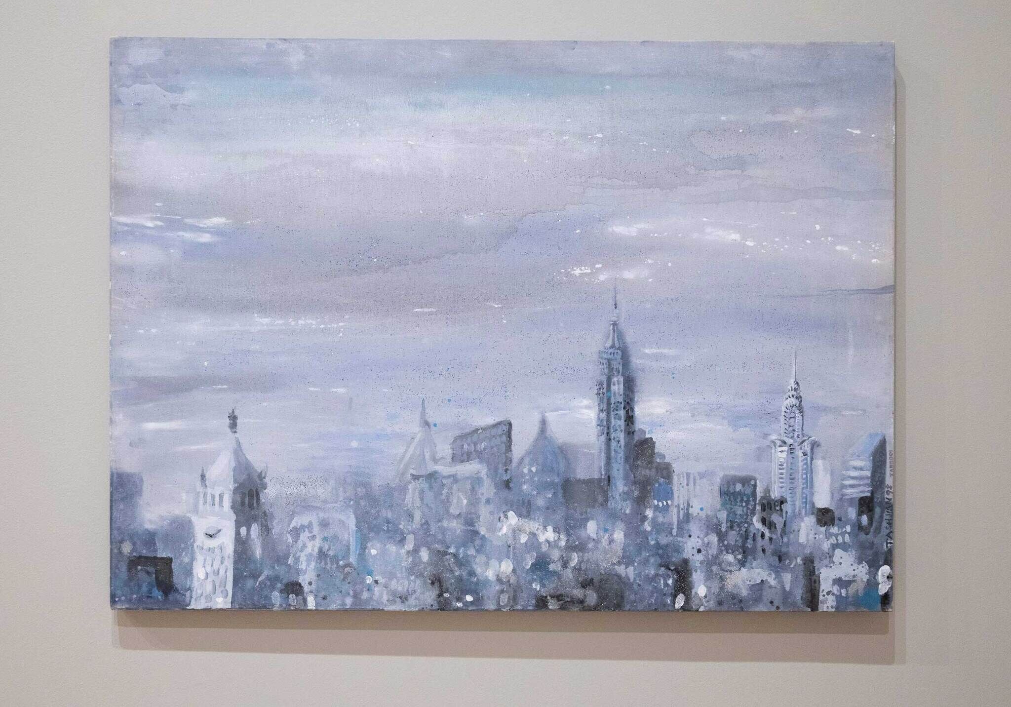A painting of a city skyline in shades of blue and gray, featuring tall buildings under a cloudy sky.