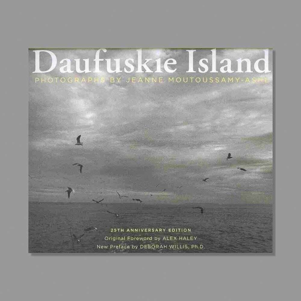 Cover of "Daufuskie Island" by Jeanne Moutoussamy-Ashe, featuring a black-and-white photo of birds over the ocean. 25th Anniversary Edition.