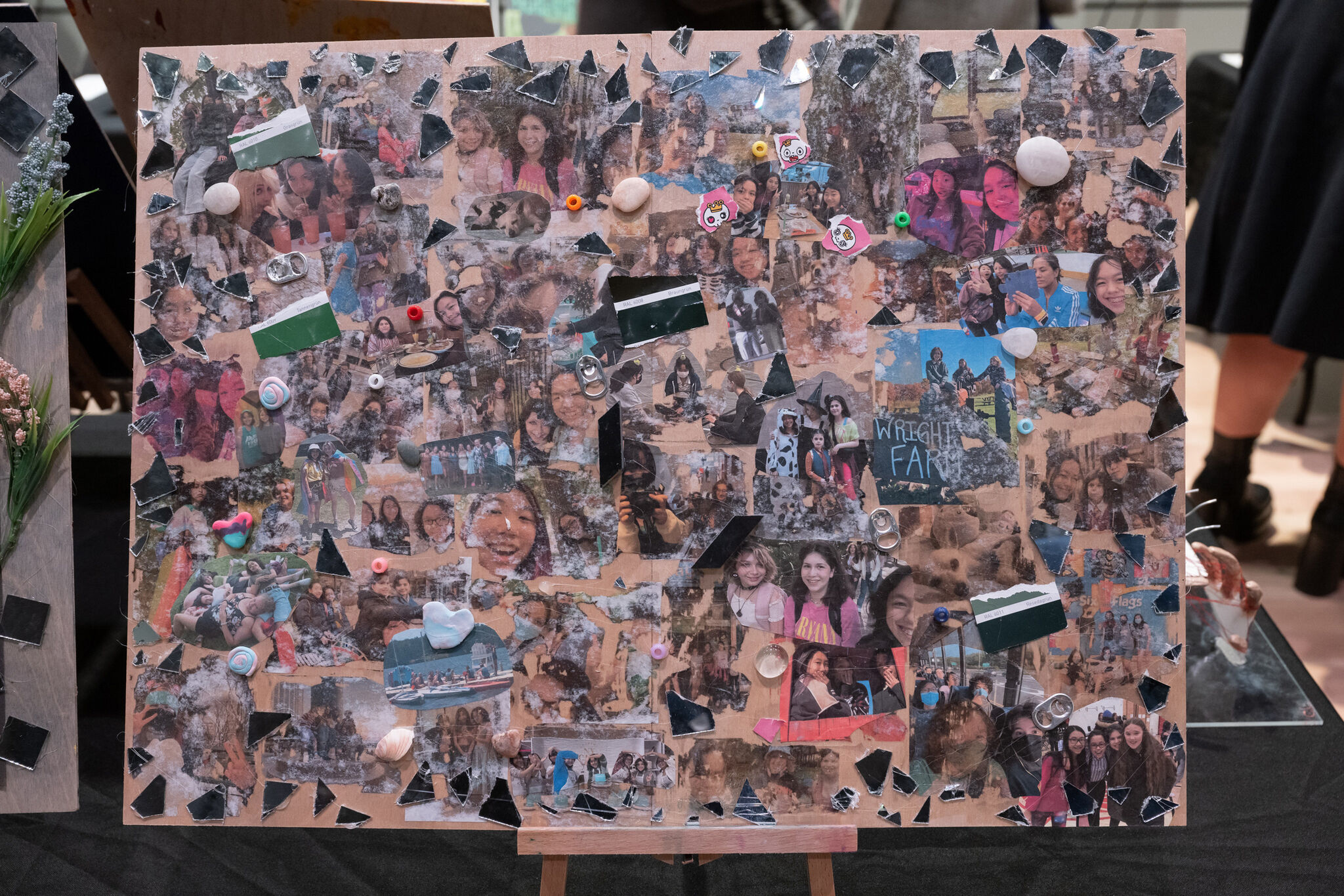 A collage of various photos featuring people, decorated with small objects like beads and shells, and pieces of black material.