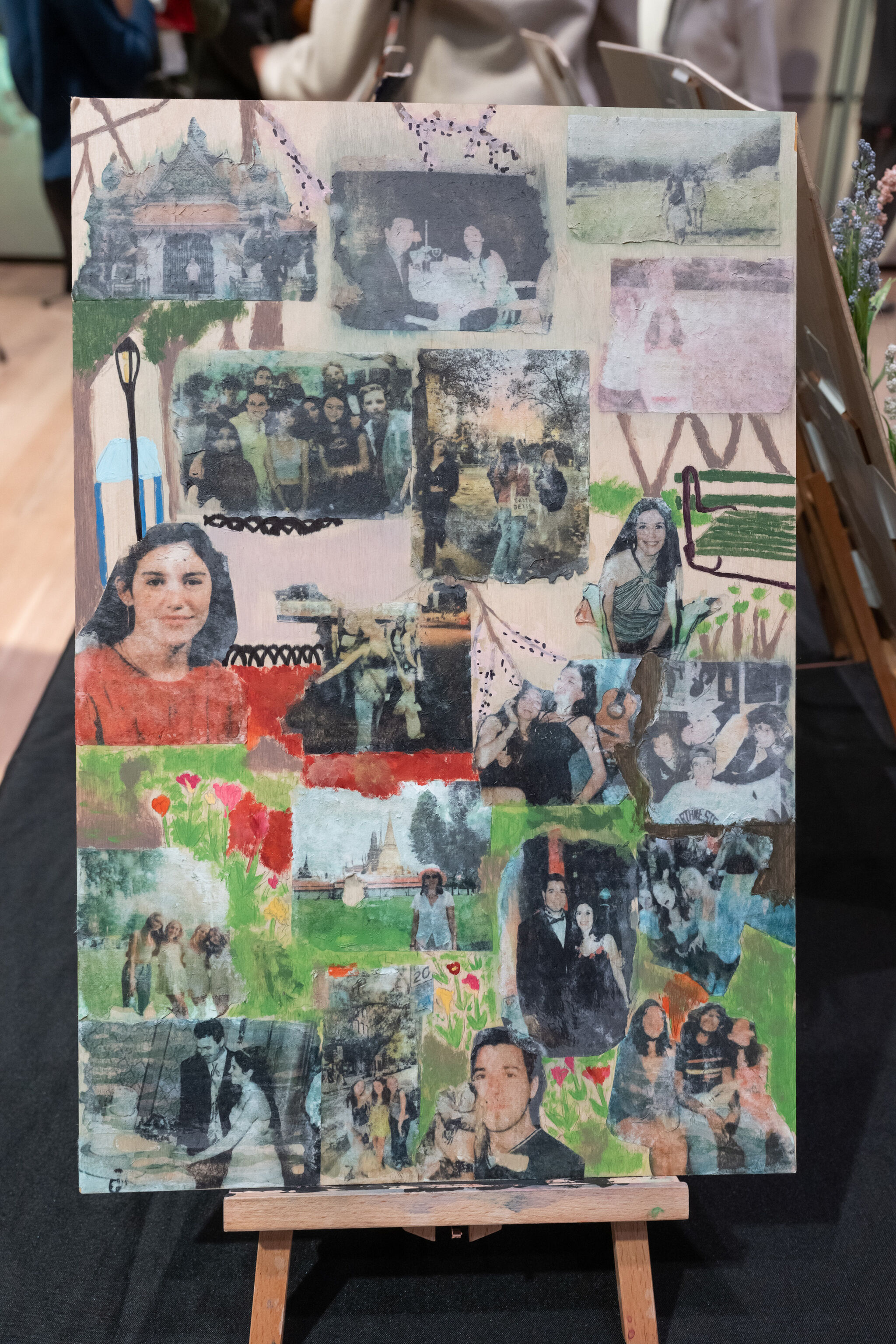 Collage of various photos and paintings on a wooden board, featuring people, landscapes, and abstract elements, displayed on an easel.