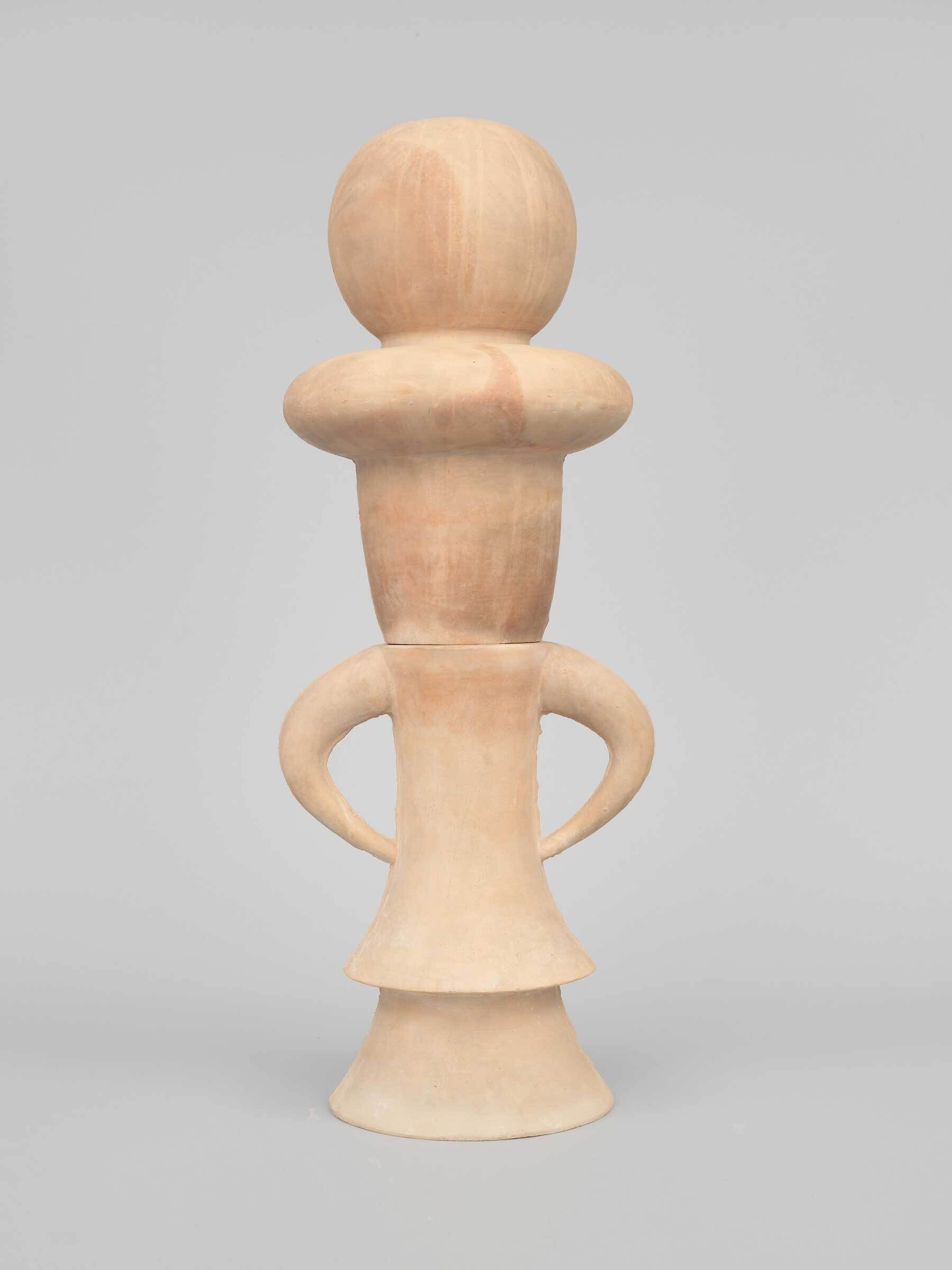 Tan ceramic sculpture with a round head, wide collar, and two curved arms on a flared base.