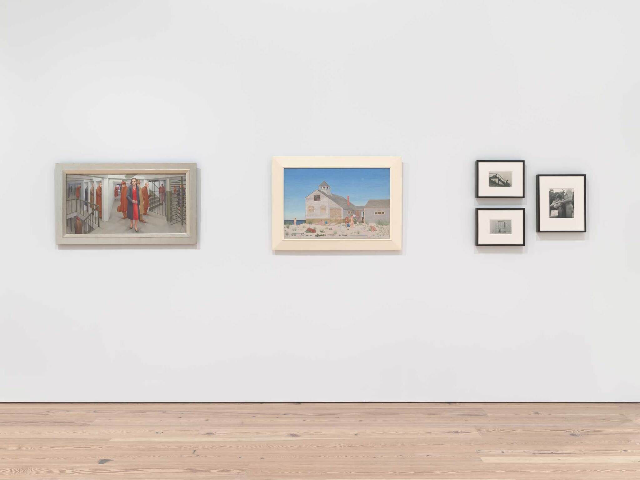 Three paintings and three black-and-white photographs are displayed on a white gallery wall above a wooden floor.