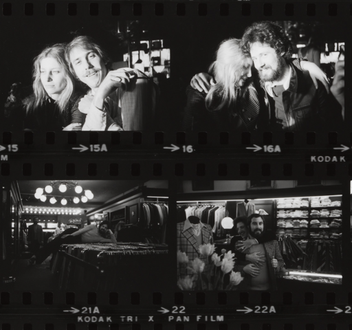 Four black-and-white film photos show two people together in a clothing store, hugging, laughing, and posing playfully.