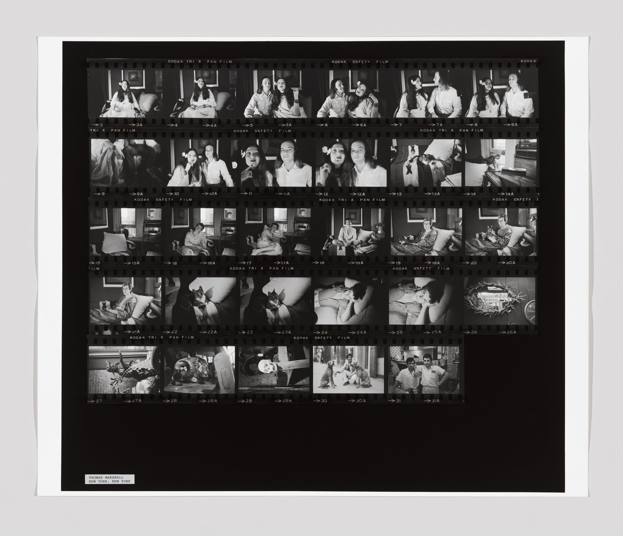 A contact sheet with multiple black-and-white photos showing two women, a dog, and various indoor scenes.