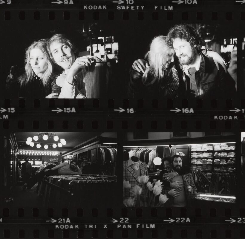 Two couples laugh and embrace in candid black-and-white shots inside a clothing store and bar.