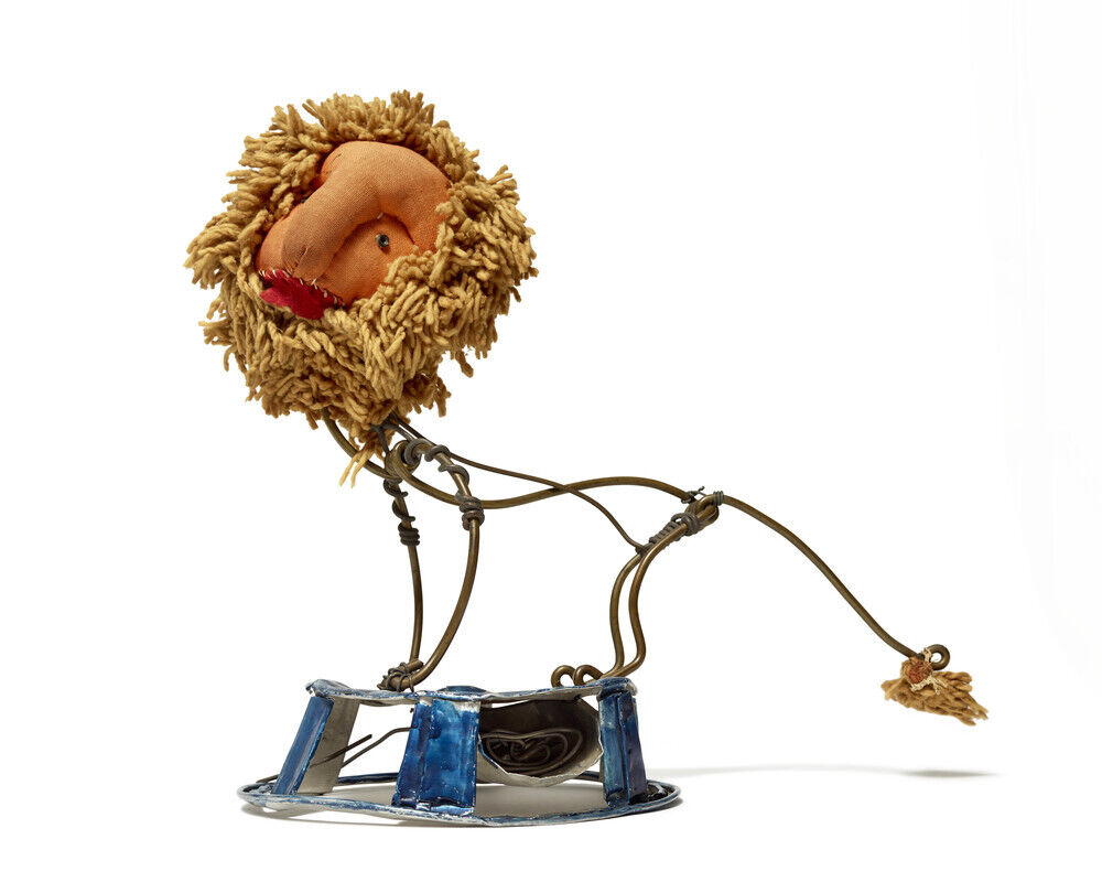 A small wire sculpture of a lion with a mop-like mane standing on a blue metal base.