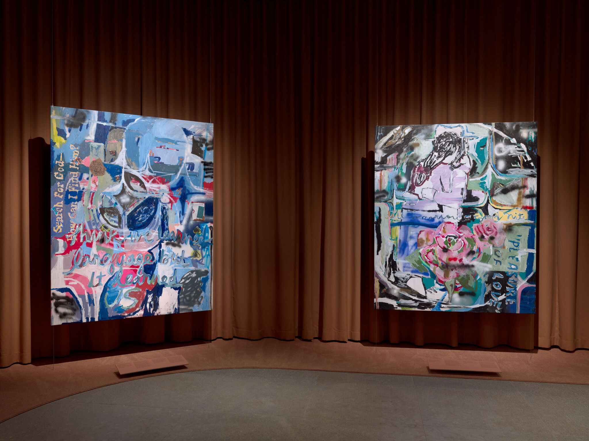Two large colorful abstract paintings hang against a brown curtain in a gallery space.