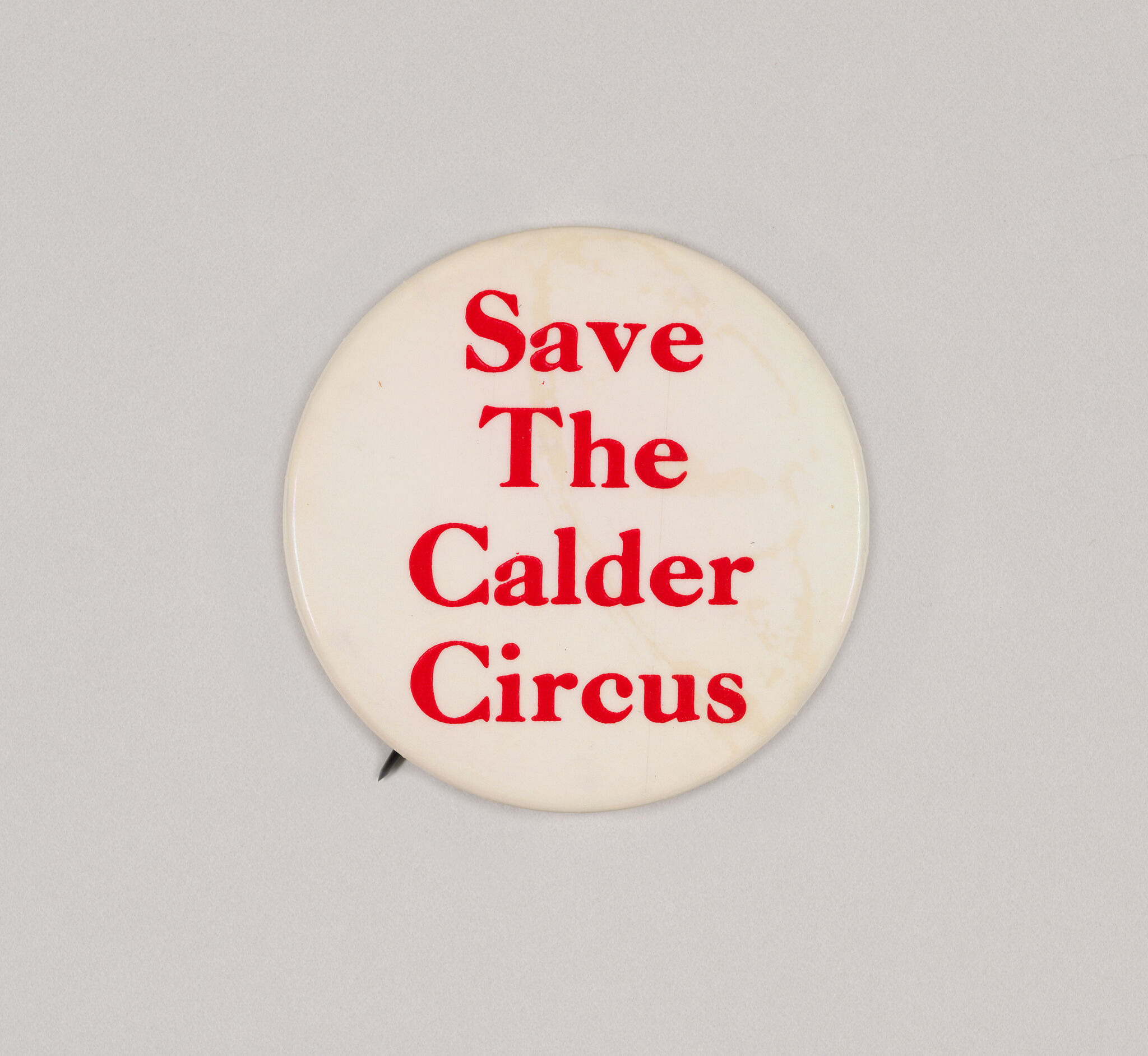 Round white pinback button with red text reading "Save The Calder Circus".
