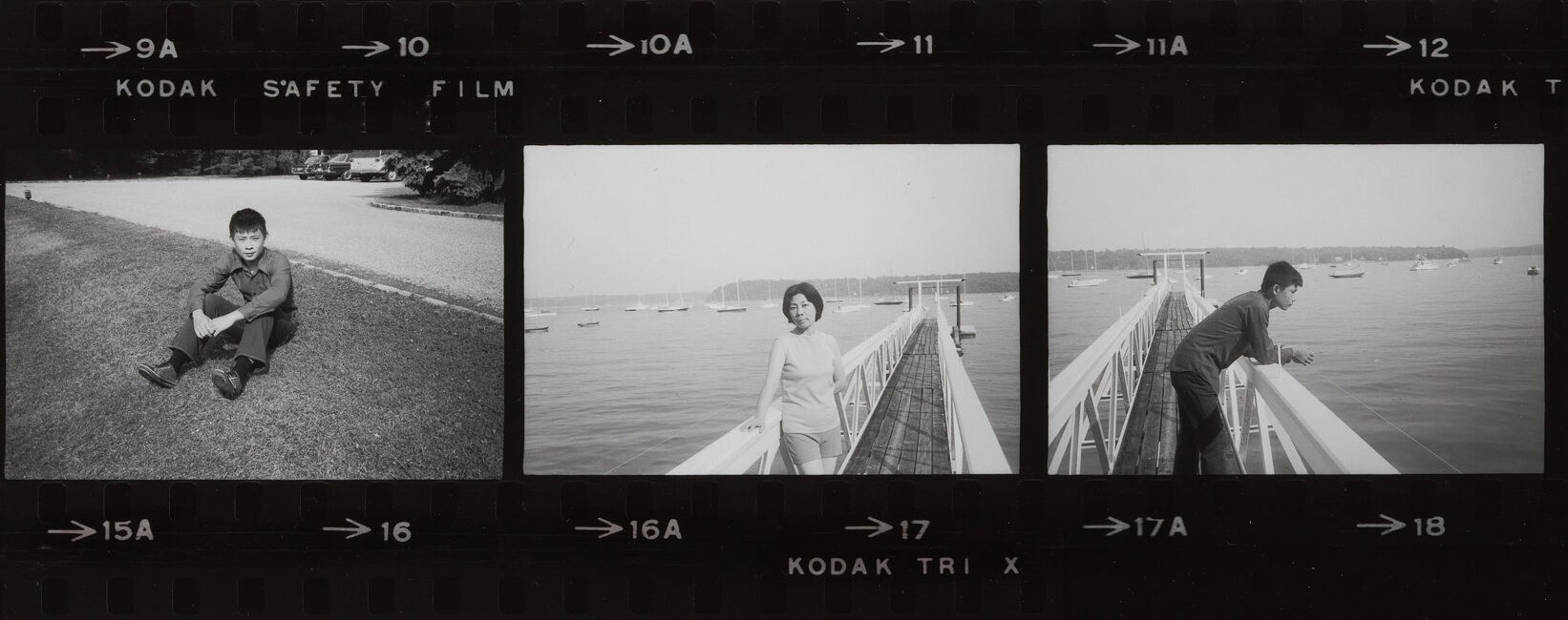 Three black-and-white contact prints showing people by a waterfront: boy sitting, woman on pier, boy leaning over railing.