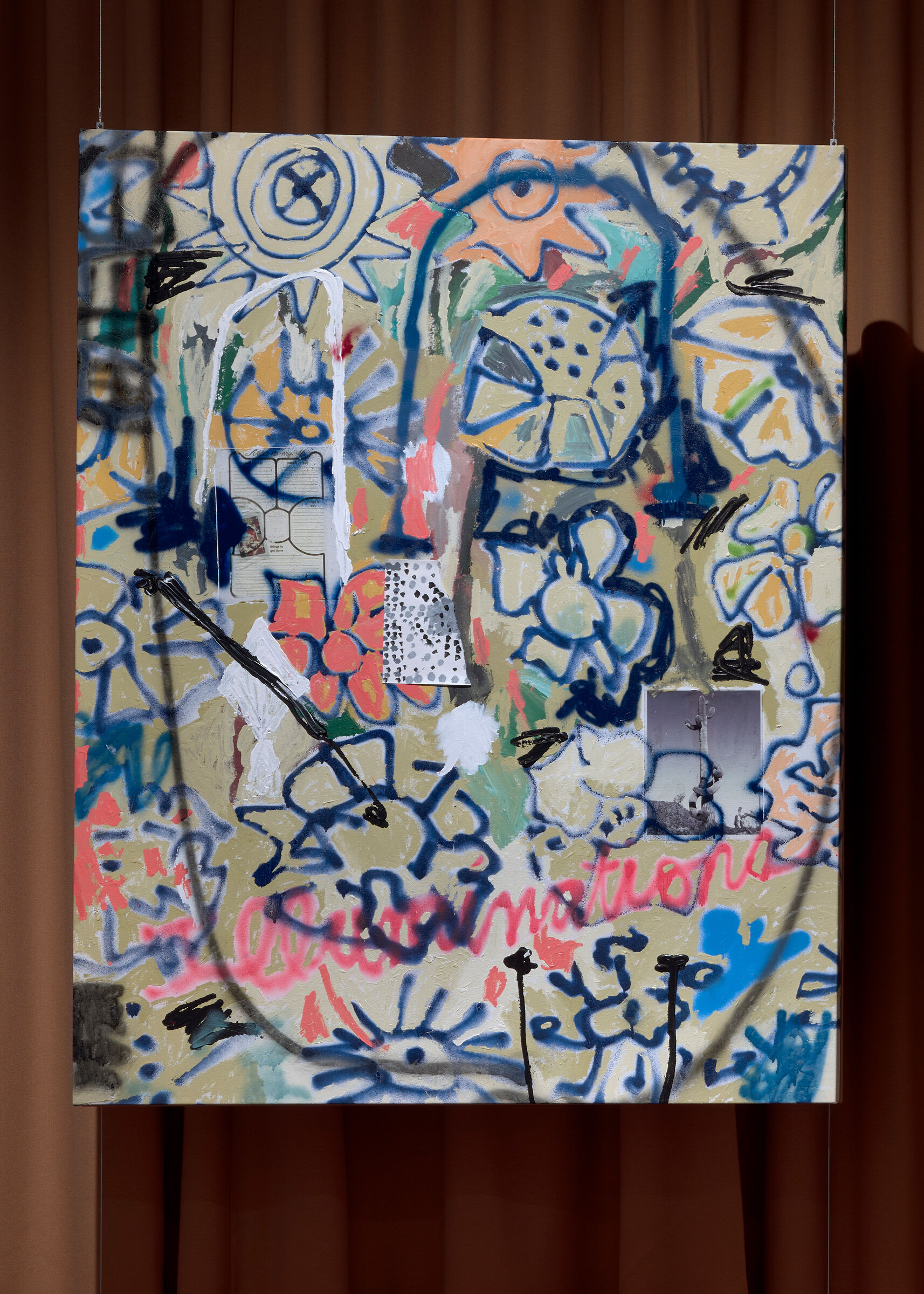 A large colorful abstract graffiti-style painting with flowers hangs against a brown curtain.