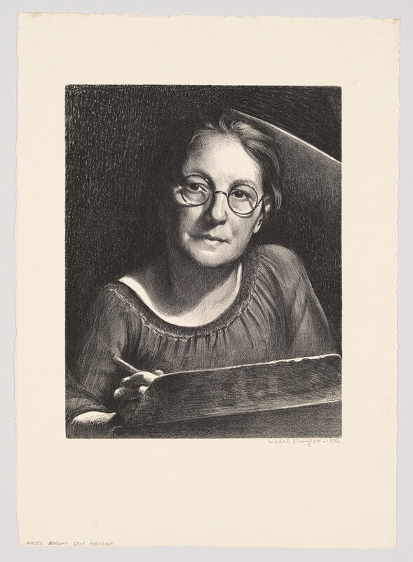 Woman wearing round glasses looks toward the viewer while holding a pencil and sketchbook.