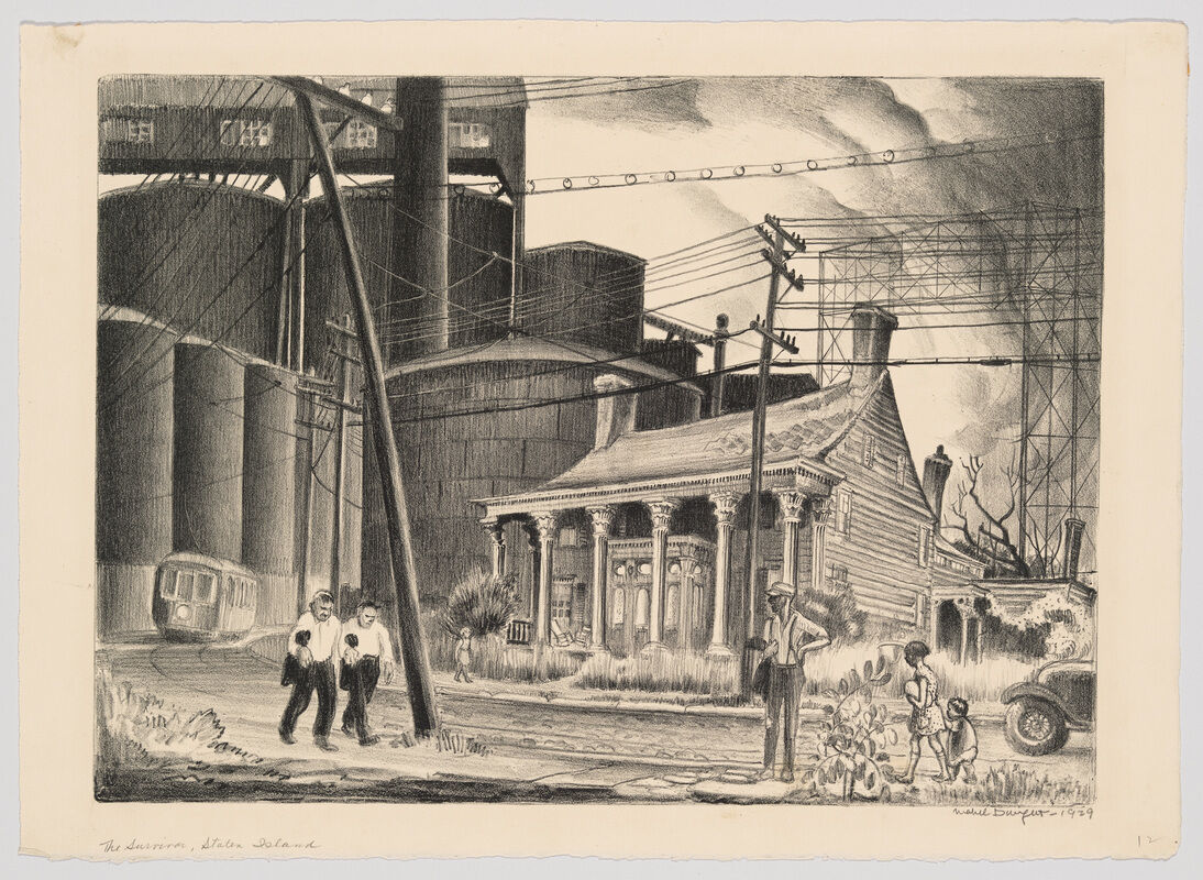 A worn wooden house stands amid industrial silos while people walk and talk along the street.