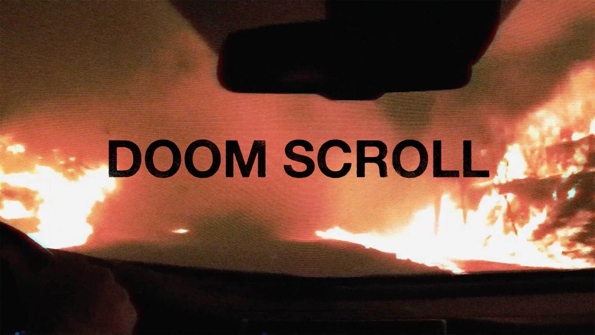 Title card for the show that reads “Doomscroll” in black font over the view from inside a car's windshield to a landscape of fire.