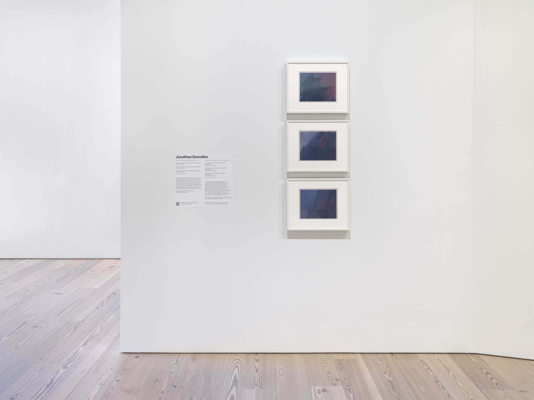 Three small framed square photographs hung vertically on a white gallery wall.