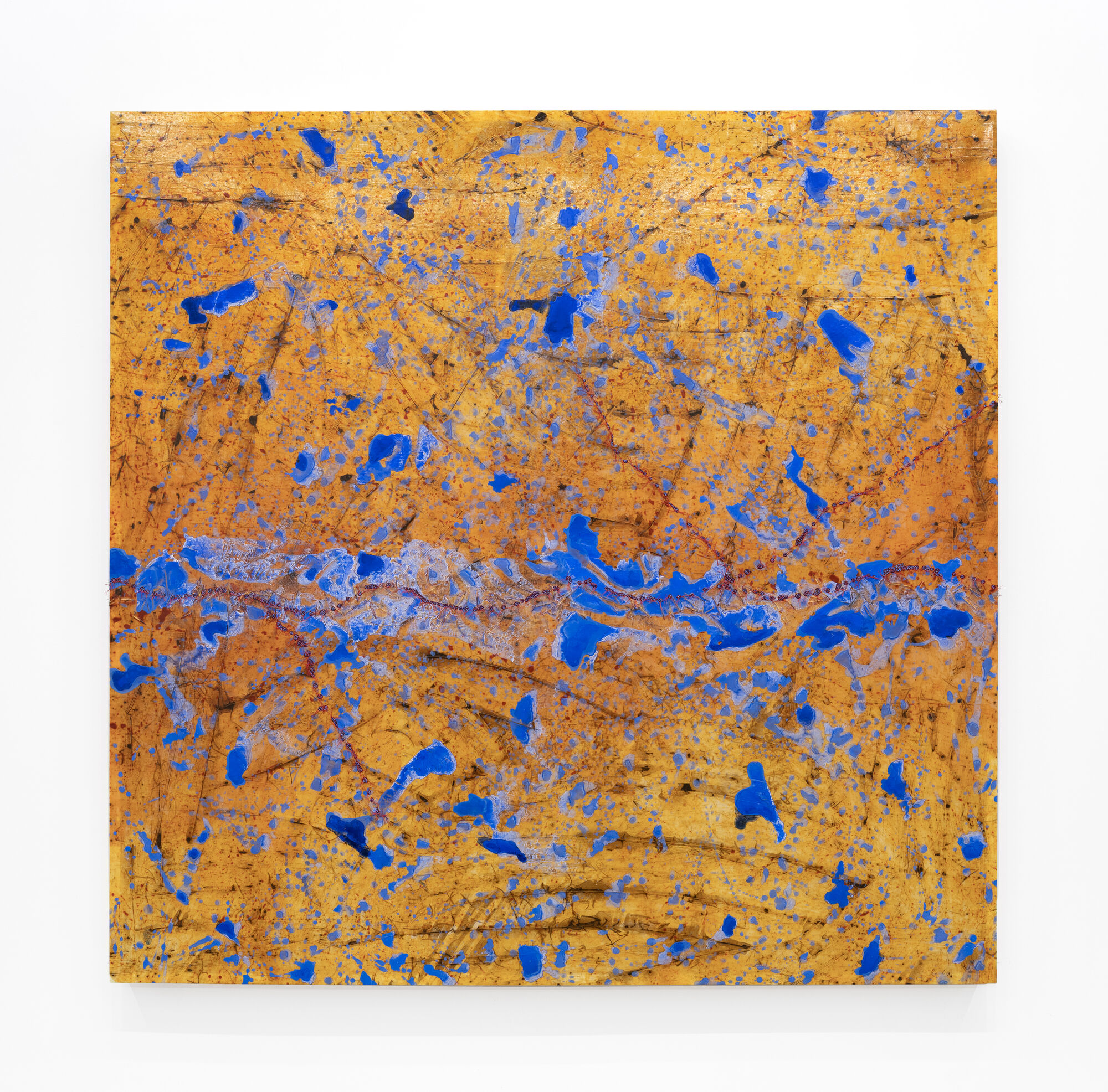 Large abstract painting with orange background covered in scattered bright blue paint splatters and marks.