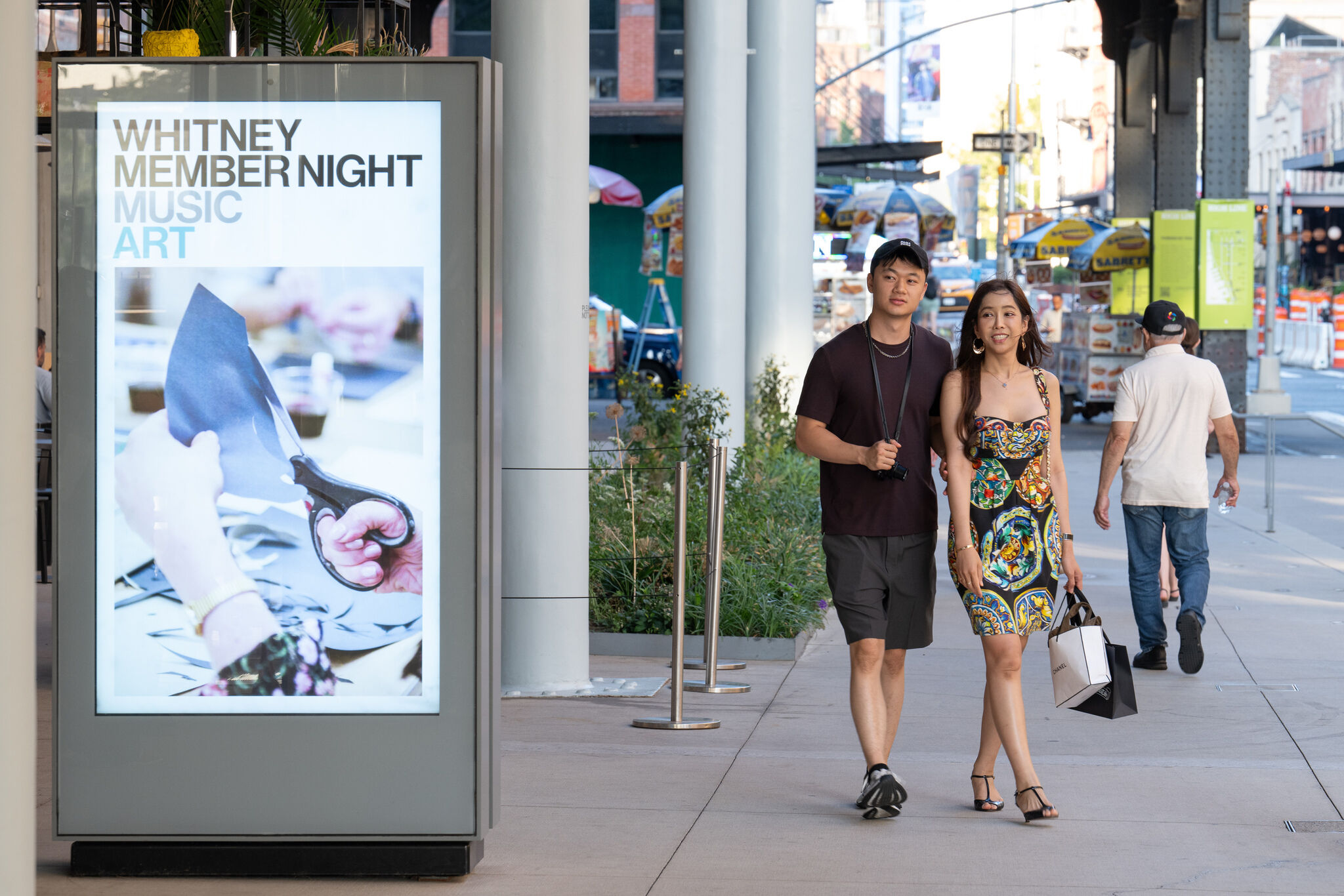 A young couple walking side by side against a city backdrop.