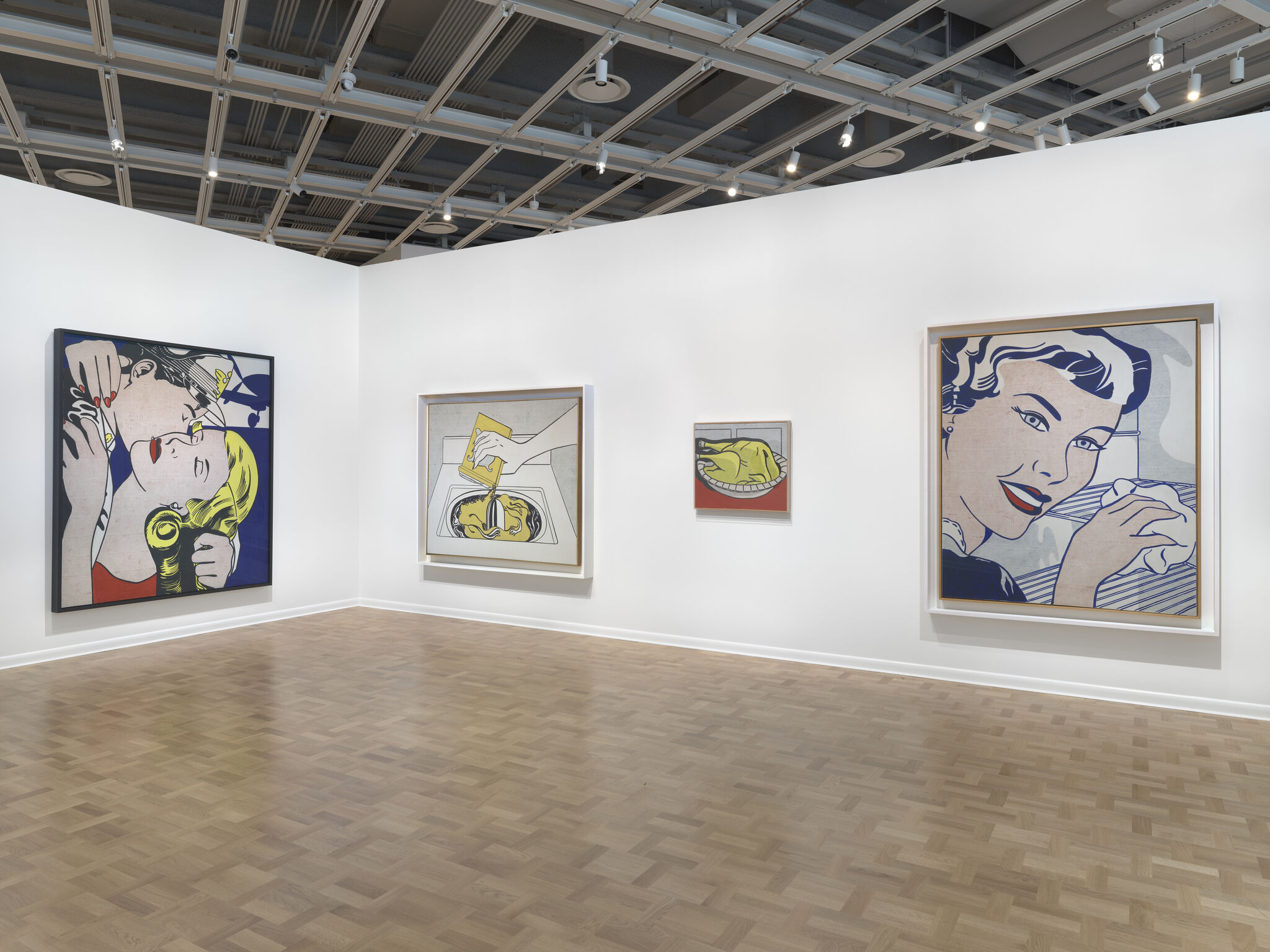 Gallery wall displaying large colorful pop art paintings of women and everyday objects.