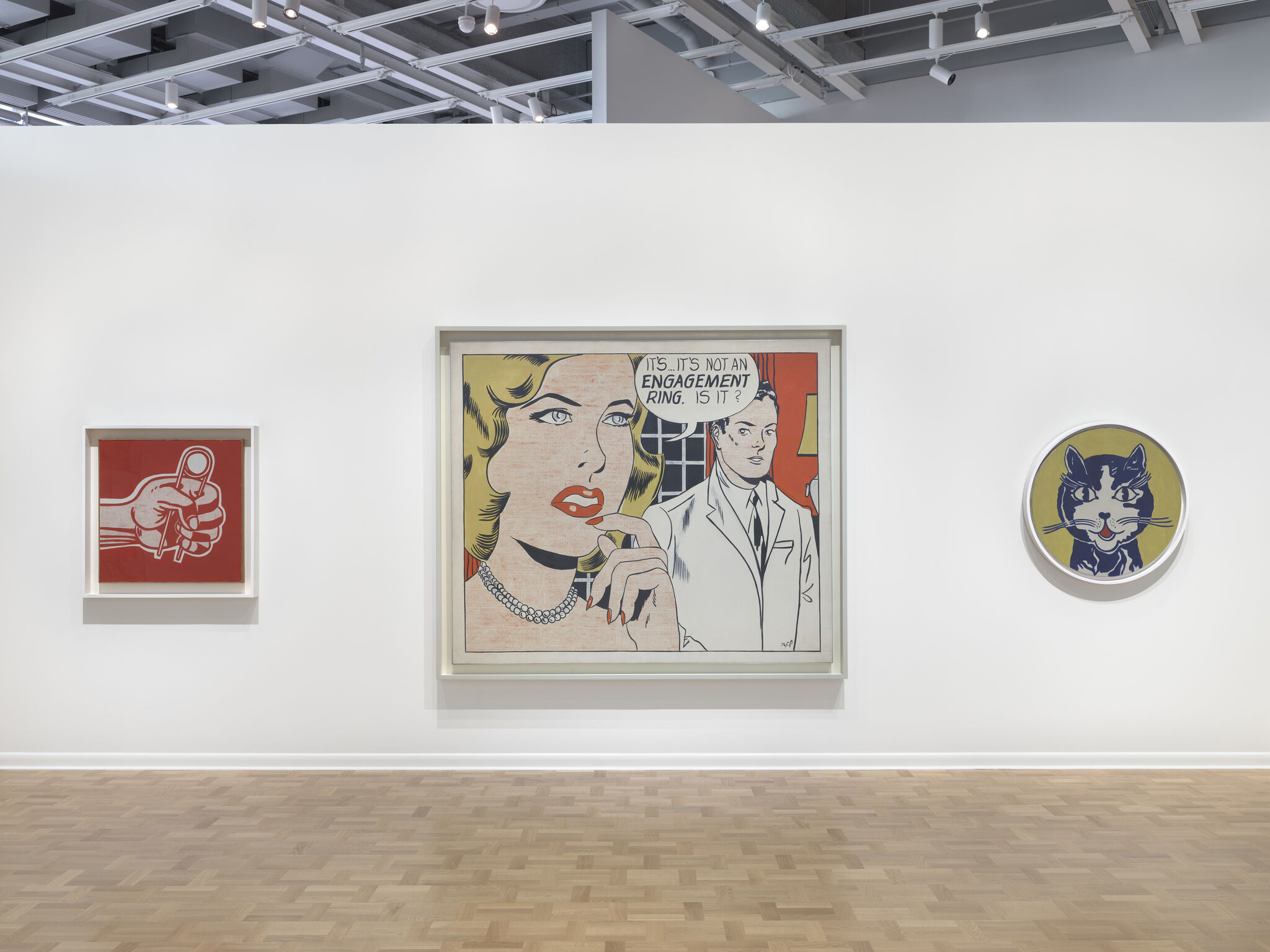 Large pop-art painting of a woman asking, "It's... it's not an engagement ring, is it?" on gallery wall.