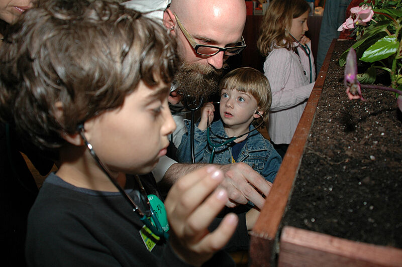 Kids listen to plants during a family program
